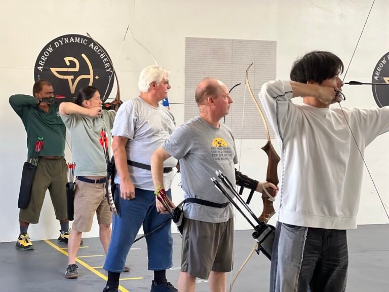 Adult archers at full draw on the shooting line